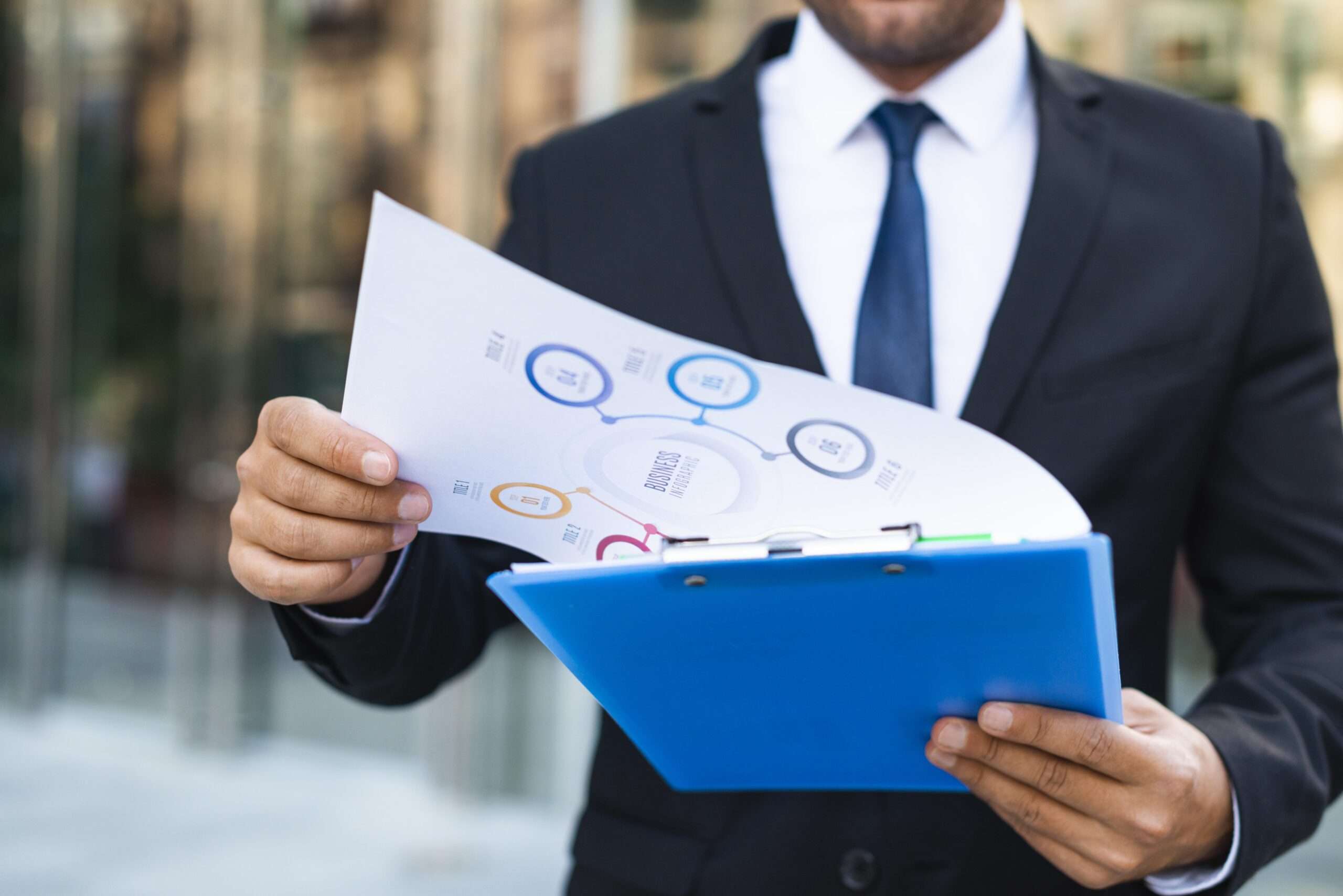 front view business man looking charts scaled